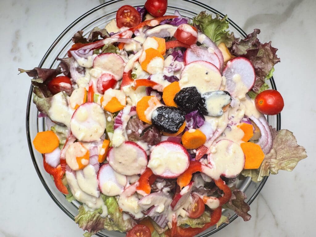 Colorful mixed vegetable salad with radishes, tomatoes, carrots, and leafy greens - hydrating foods for jetlag recovery