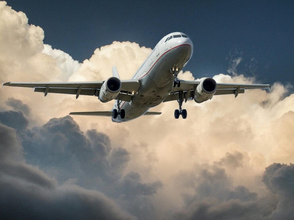 Commercial airplane flying through clouds - representing travel and jetlag recovery strategies