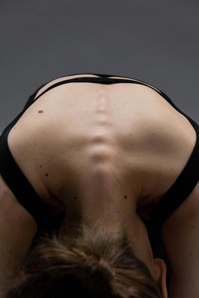 Artistic black and white photograph showing the human spine, representing the lumbar spine area assessed in bone density testing