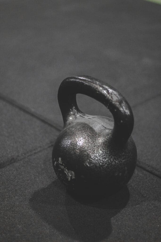 Black kettlebell representing resistance training exercises crucial for bone health and osteoporosis management