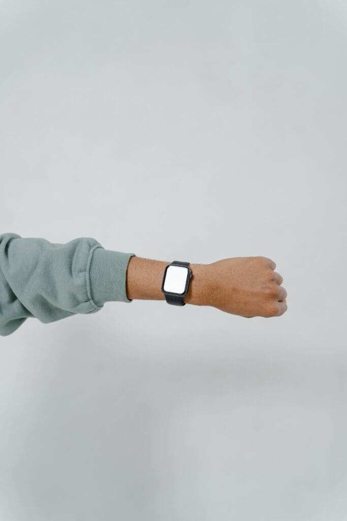 Outstretched arm wearing a wrist fitness tracker that measures resting heart rate